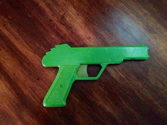 Items similar to Rubber Band Gun Green Plastic Vintage Toy Gun on Etsy