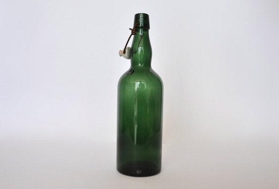 Vintage German green beer bottle with ceramic cap. Green.