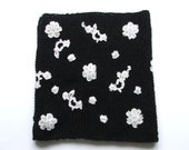 Hand knitted black and white scarf with lace flowers.