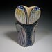Ceramic owls, owl sculpture, art. Owl Person Standing in the Rainbow in the Field of Grass