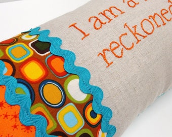 Hand-embroidered pillow "I am a force to be reckoned with." in orange, turquoise, brown