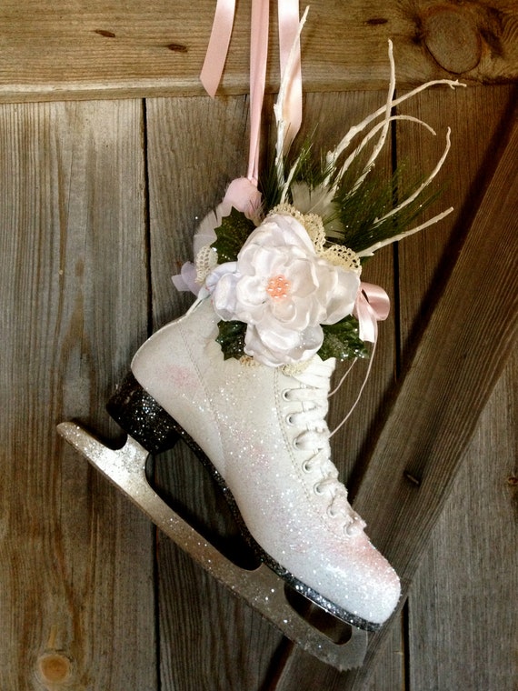 White ice skate door hanging trimmed in pink.