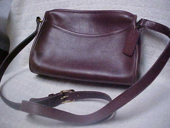 Dark brown classic Coach purse with adjustable shoulder strap