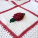 Crocheted roses and lace afghan flower throw blanket white pink red green leaves scalloped edging granny square blocks bedding