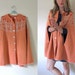 vintage 1970s Peach Knit Sweater Cape Shawl with Buttons and Folk Floral Print -- S/M/L