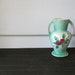 Vintage small jade green bud vase with red flowers