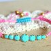 Friendship bracelet Turquoise and pink braided with real Turquoise swarovski rhinestones .