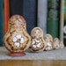 Five Russian Matryoshka Dolls with pyrography faces