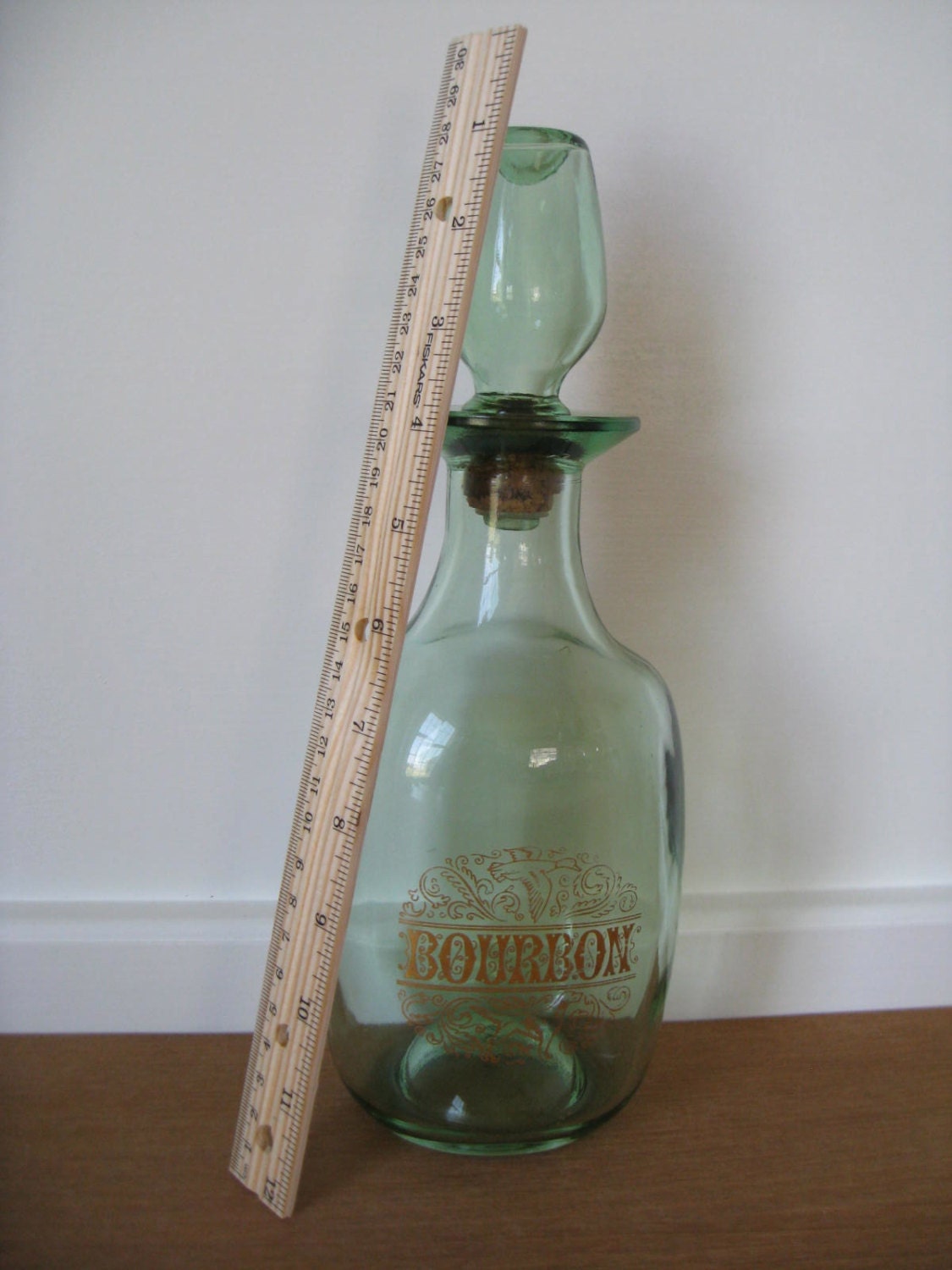 Vintage green glass bourbon decanter with gold lettering and