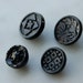 Collection of 4 vintage black pressed glass buttons with floral, geometric and 6 pointed star patterns 5/8" and 1/2" dia. wire loop shank