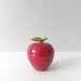 red solid marble apple paperweight with brass stem