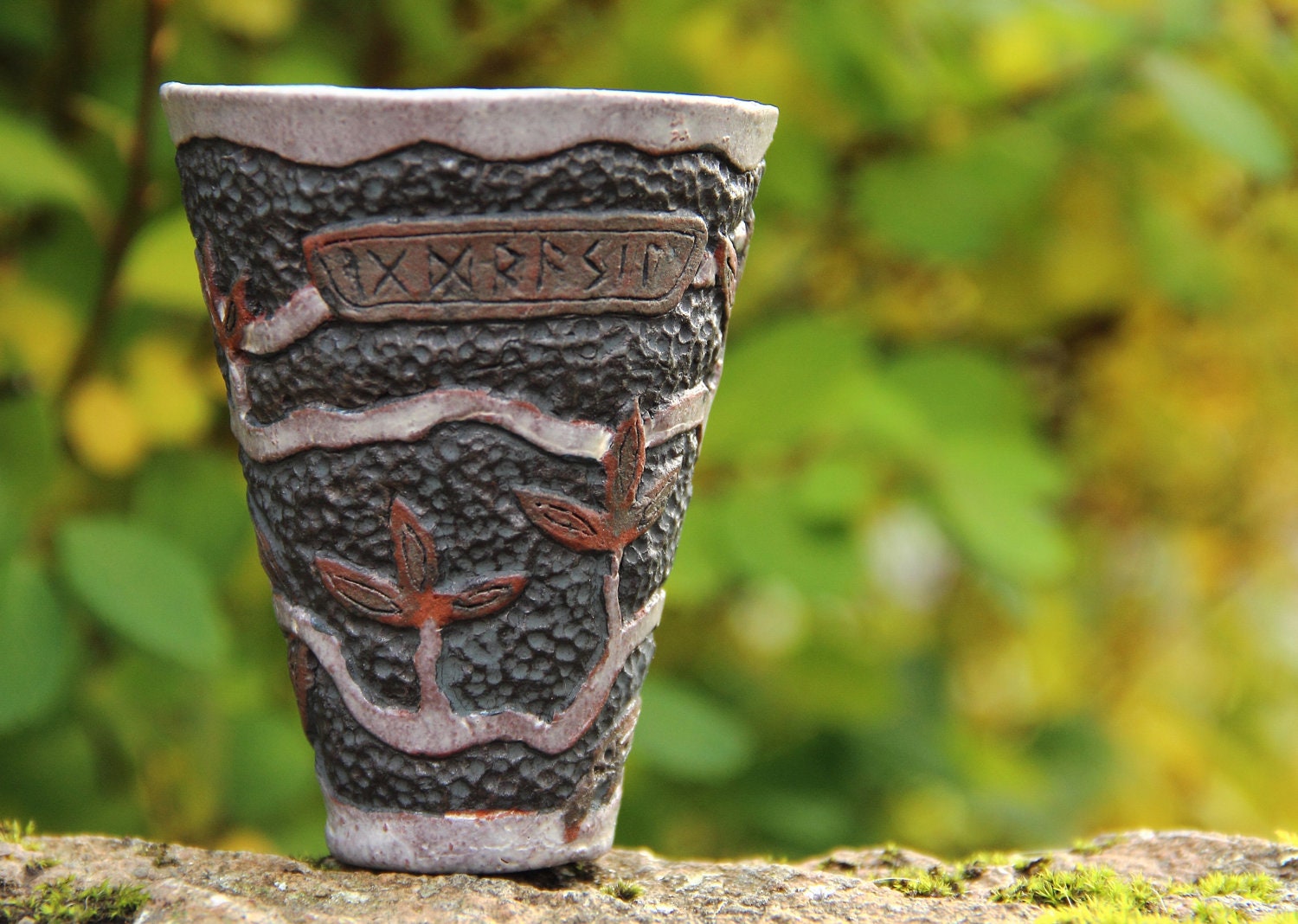 Viking mead or coffee cup with carved pattern representing