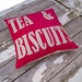 Sample item . TEA and BISCUITS word Cushion/pillow in hot pink & oatmeal.