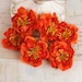 BRAND NEW: Bel Canto Orange small fabric flowers with stamens on center.