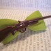 Rifle On Lime Green Ribbon Bow - Alligator Hair Clip