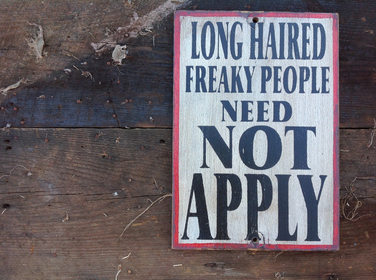 Long haired freaky people sign made from reclaimed plywood