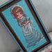 Kitsch Hollie Hobby Holding a Sweet Kitten Painting in Plastic Woodtone Frame