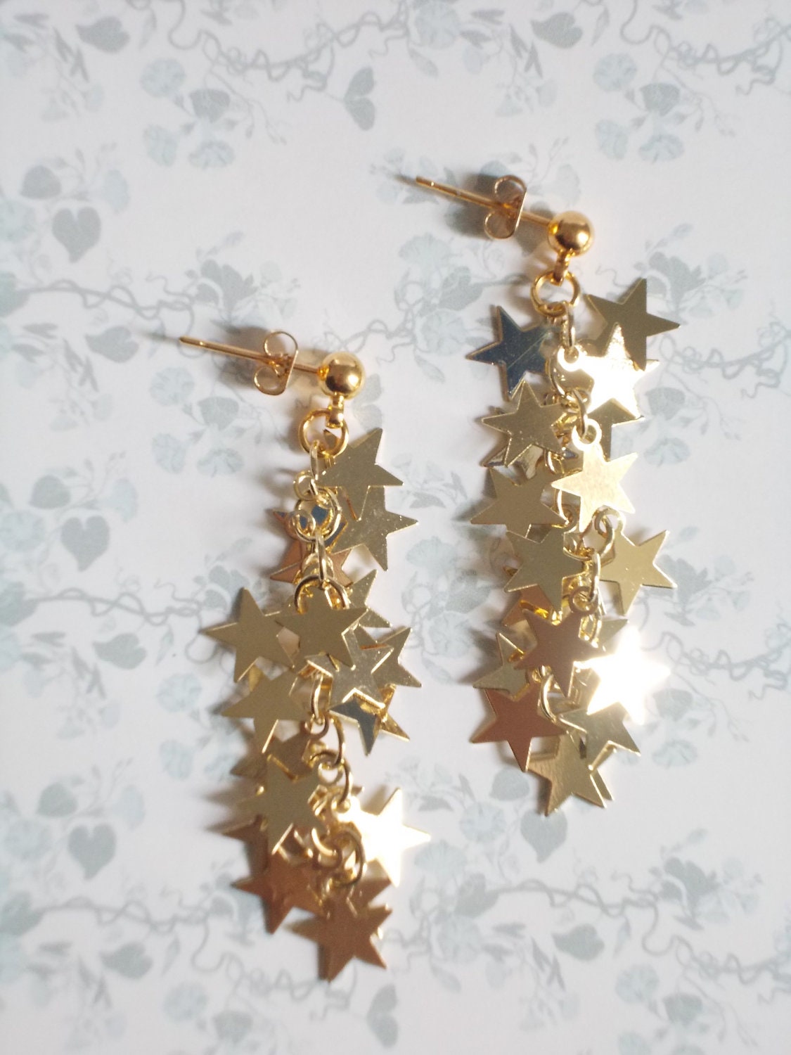 Gold star earrings. Long dangle with tiny sparkling by LilyandFern