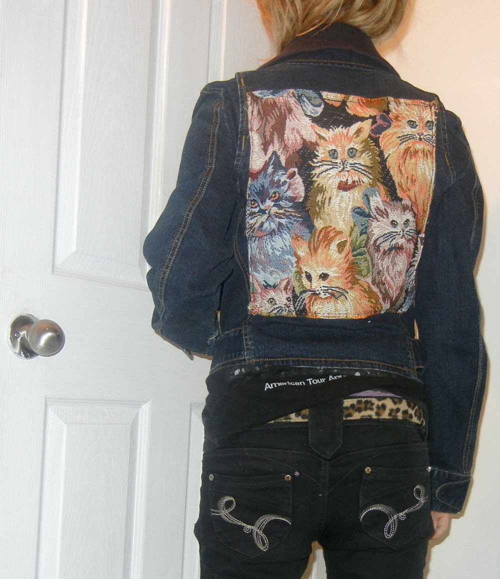 Denim jacket with cat backpatch. Size small.