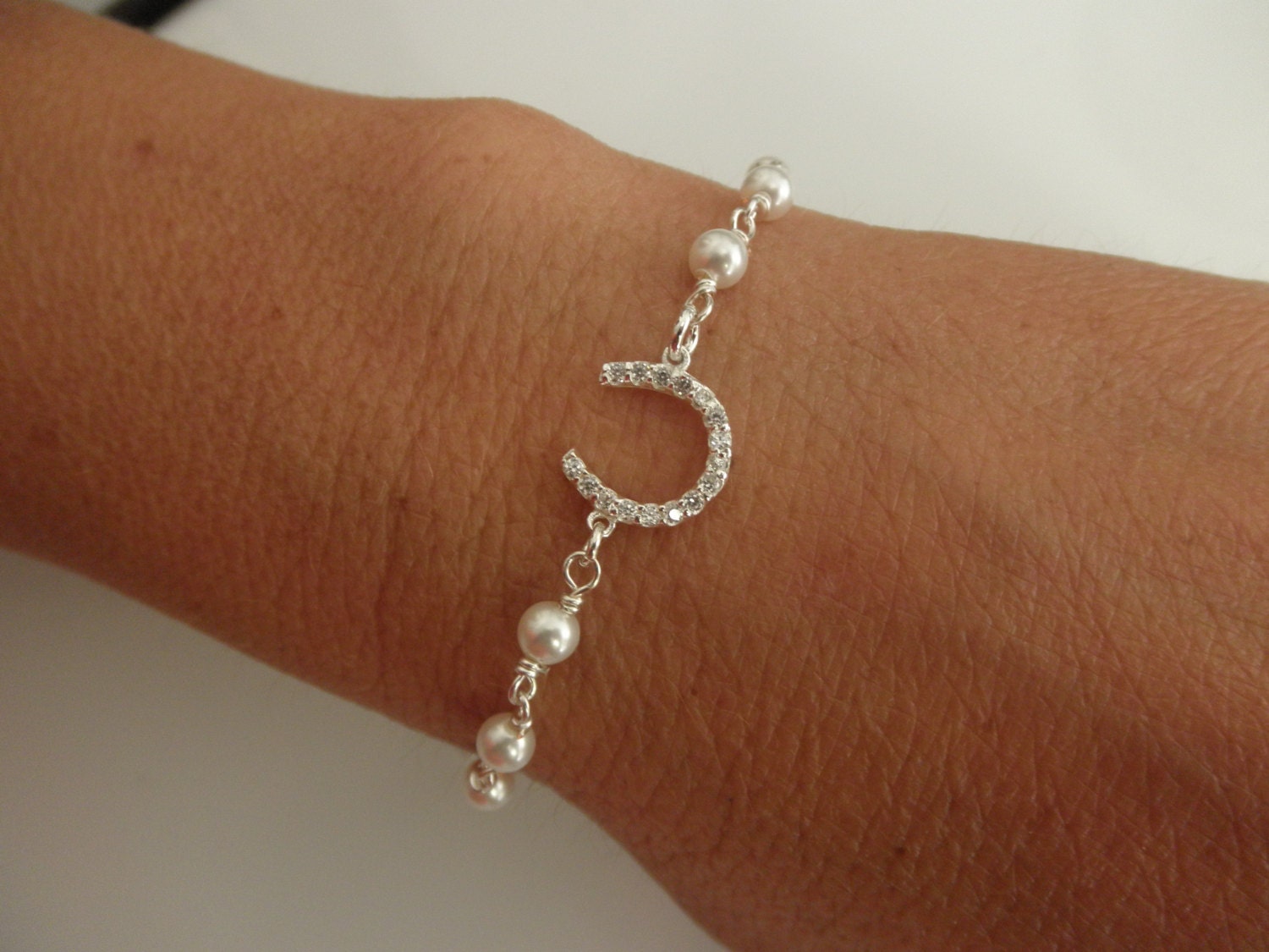 CZ sterling silver horseshoe bracelet with swarovski pearls