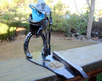 Horseshoe cowboy digging posthole.