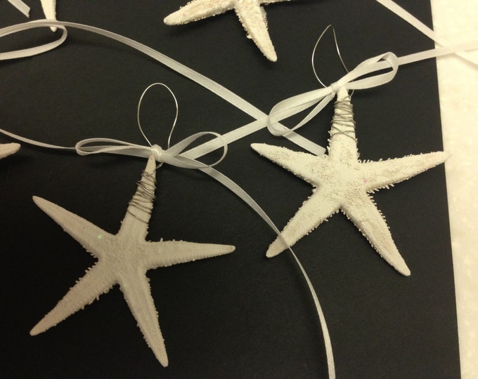 8 Actual Mini Starfish. Painted White with a touch of Glitter, wire wrapped and an addition of Ribbon.