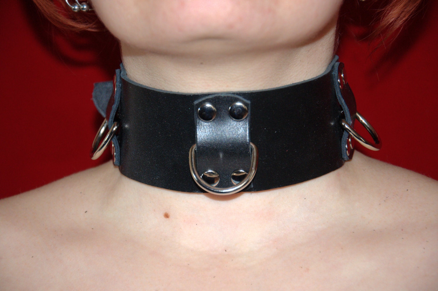 Handmade black leather collar, about 2" (about 50 mm) wide, with three halfrings