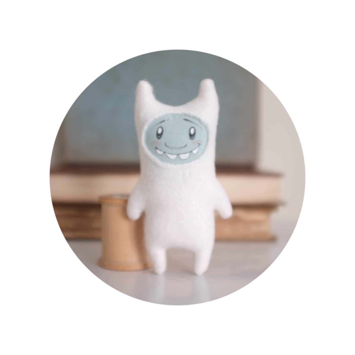 Miniature yeti plush monster toy with illustrated face