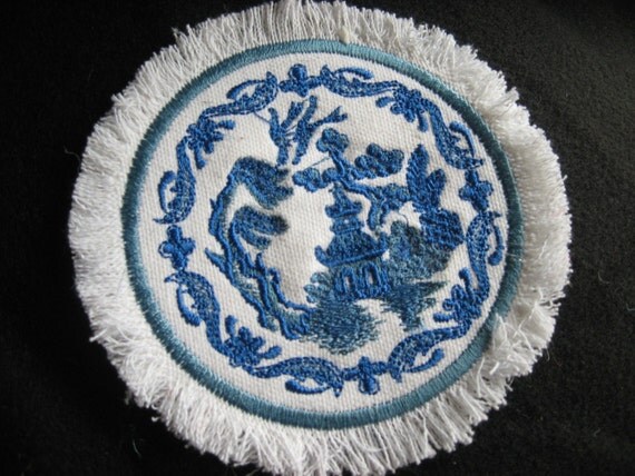 Blue Willow Miniature Rug that is round on white linen for