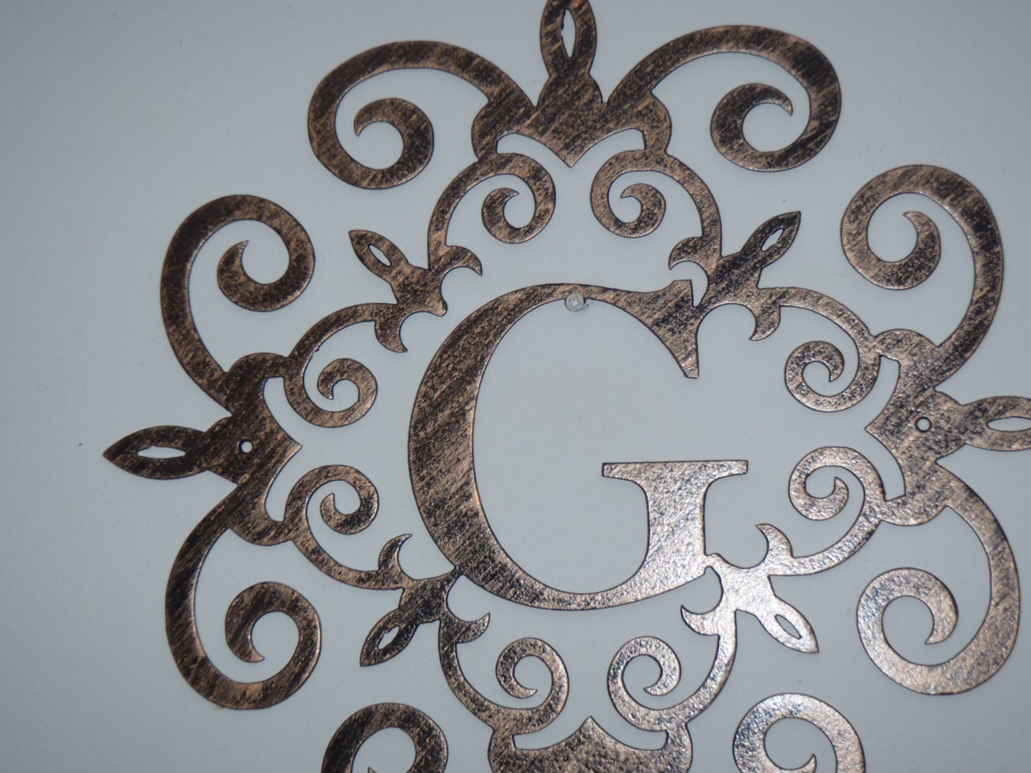 Family initial Monogram inside a Metal Scroll with Wall