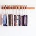 Custom made wooden book rack / bookshelf in Oak. The pins are also bookmarks.