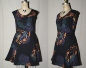 Black Cotton Jersey Spring Dress with bronze metallic boar skulls, teal feathers,  purple firework shells screenprinted