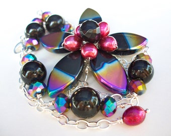 Black flower necklace, asymmetrical beaded wire wrapped flower with purple rainbow AB finish, bead flower jewelry