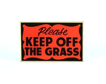 vintage neon cardboard "KEEP OFF GRASS" sign
