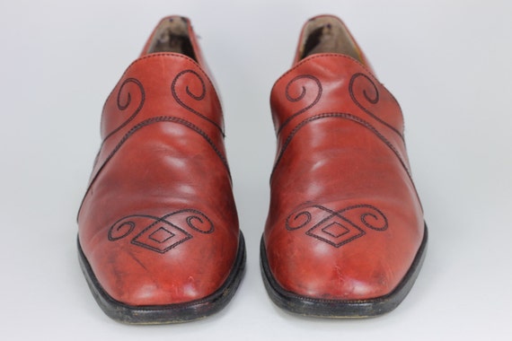 red leather shoes made of skin