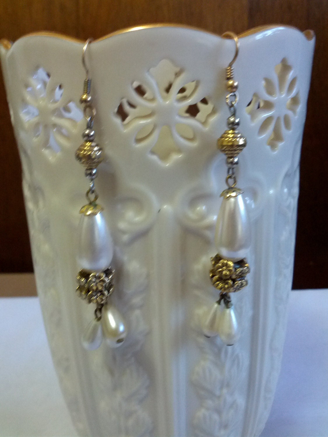 Beautiful dangle earrings set with gold tone metal and faux