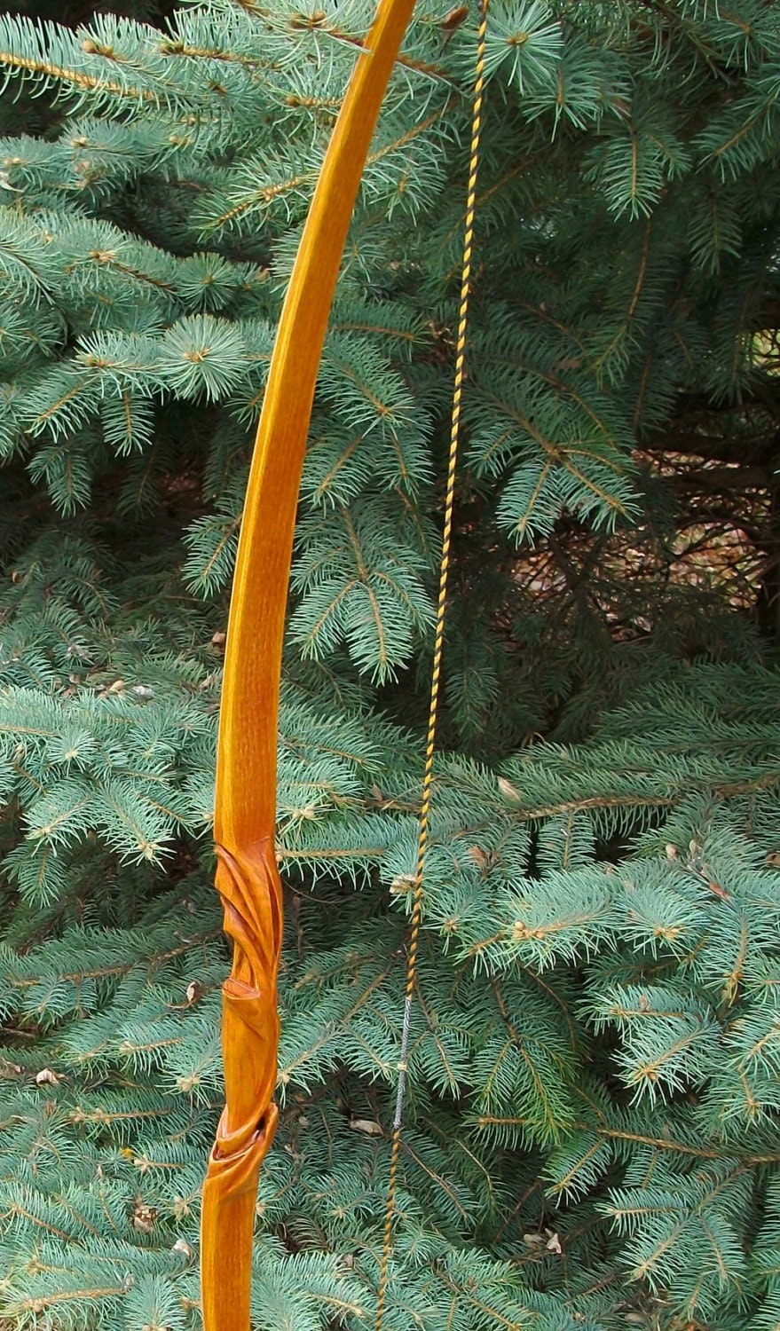 My latest custom carved longbow, built from orange Osage r/Archery