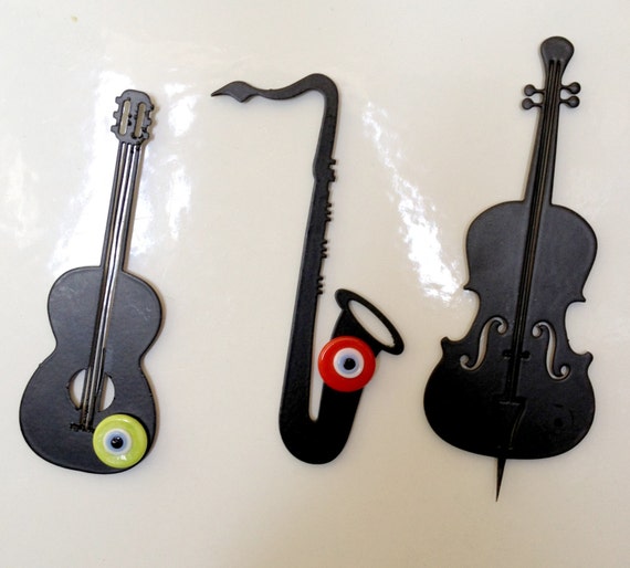 metal cut orchestra musical instruments cello, guitar, saxophone ...
