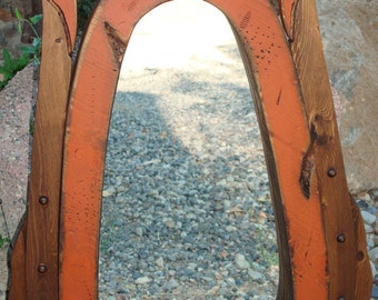 Antiqued wood horse collar mirror.Great wall decor for your home or office. This rustic mirror is made to look like the real thing.
