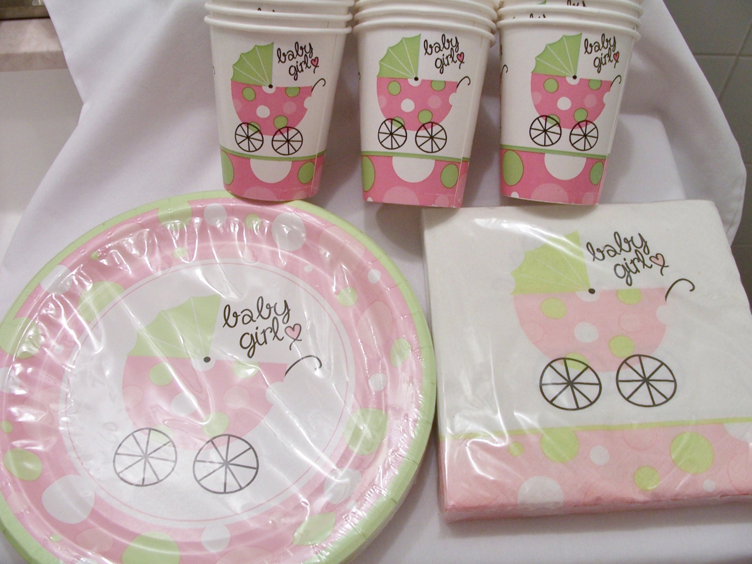 Set of soft pink and green baby shower paper plates cups and