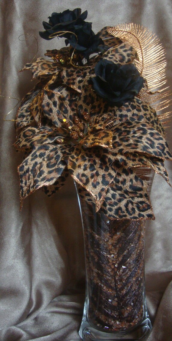 Leopard print flower arrangement with black roses. Vase is