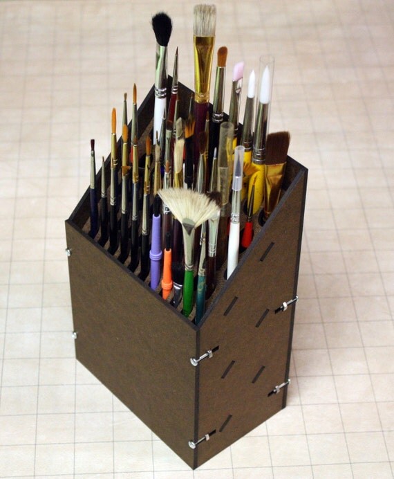 Paint brush rack holds 17 larger brushes and 32 smaller