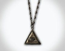 Popular items for illuminati necklace on Etsy