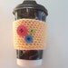 Yellow and pink Crocheted coffee cozy with 3 buttons