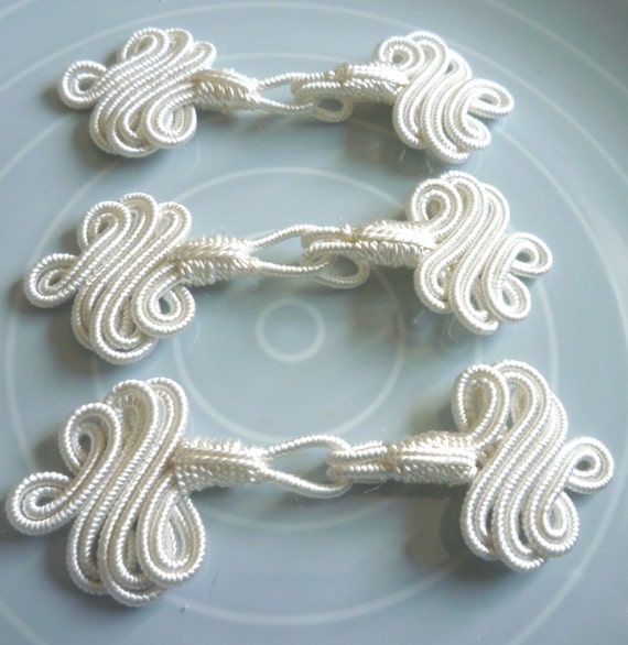 Three Decorative fasteners cream art silk