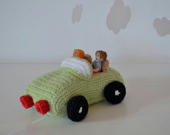 Crocheted green toy cabriolet with passengers, boy and girl handmade from modelling clay