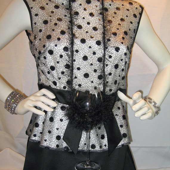 A versatile wine glass holder necklace in stretch mesh