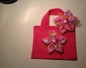 Pink canvas bag matching hair clip.