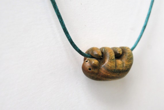 Sloth necklace carved from argentinian lignum vitae wood