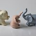 set of 3 ceramic elephant figures pastel shades white pink and sky blue